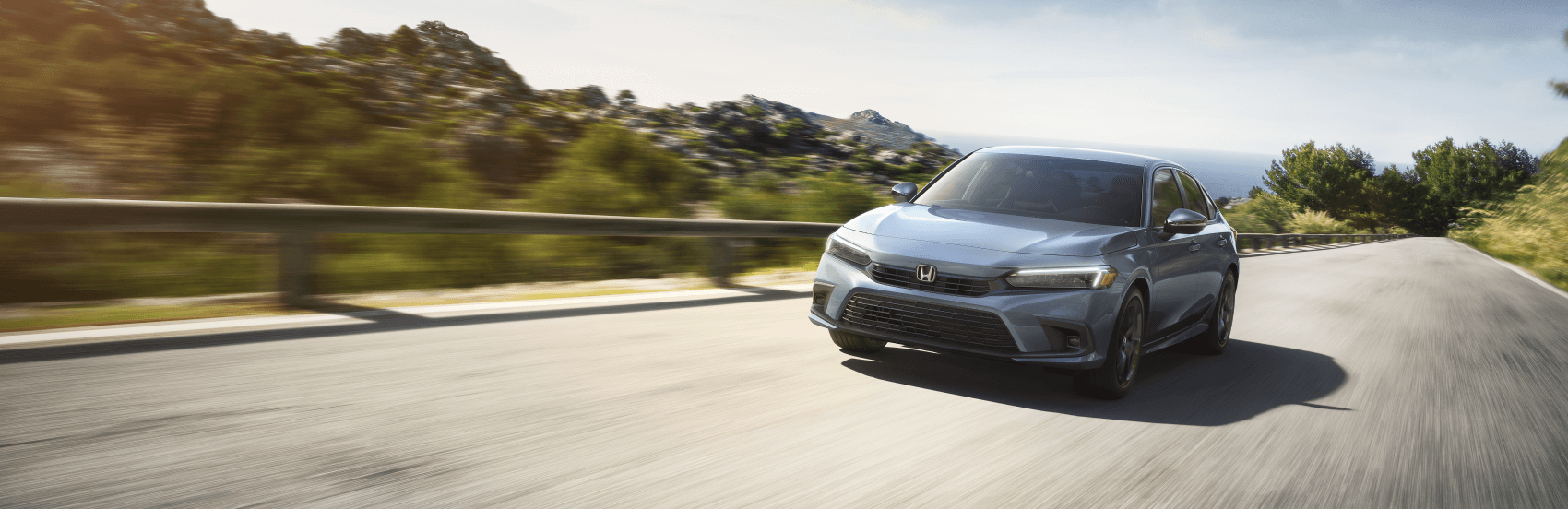 Honda Civic driving up mountainside highway